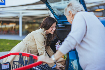 Smiling Women Loading Car Trunk After Shopping Trip