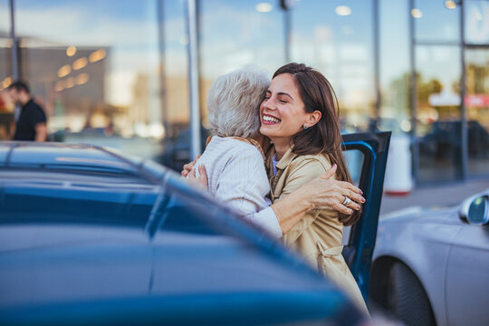 Joyful Reunion Between Grandmother And Granddaughter In Parking Lot