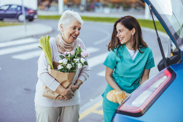 Elderly Woman and Caregiver Smiling While Grocery Shopping