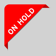 Red color of corner label banner with word on hold on gray background
