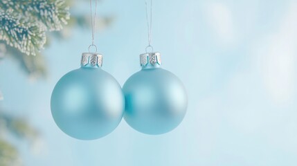 Blue glass ornaments hanging from a festive Christmas tree branch
