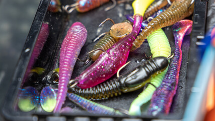 Fishing tackles and fishing baits in box .Classic Colored Fishing Lure , Beautiful Background digital image.Fishing on the lake at sunset. Fishing background.Fishing for spinning on the bass