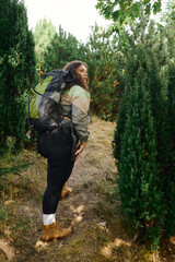 A joyful plus size woman explores a vibrant natural landscape with a backpack, embracing adventure.