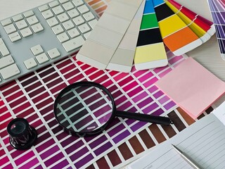 Color selection tools and design materials on a desk for creative projects