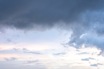 Fluffy white clouds drift across a vast, blue sky