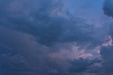 The vast expanse of a cloudless blue sky stretches towards the horizon, bathed in the warm glow of the setting sun