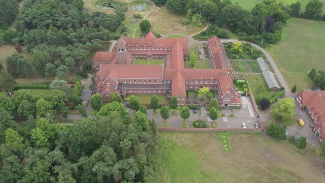 Abbey of Our Lady of Nazareth, Brecht, Antwerpen, Belgium, 15th of June, 2024, An aerial photograph highlights a historic building surrounded by lush greenery and a tranquil setting