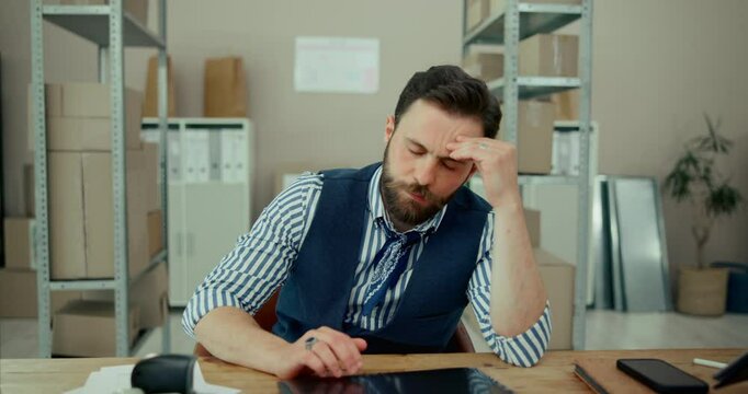 Frustrated man, laptop or logistics with stress, anxiety or mistake in debt at warehouse. Tired businessman, employee or distributor with migraine, vertigo or depression in bankruptcy or supply chain