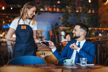 Businessman Making Contactless Payment at a Modern Cafe