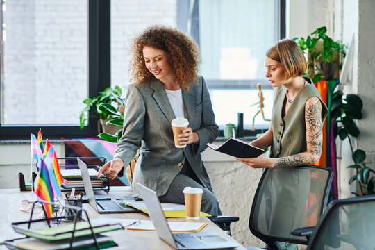 Two coworkers engage in a creative discussion while promoting LGBT inclusivity in the office.