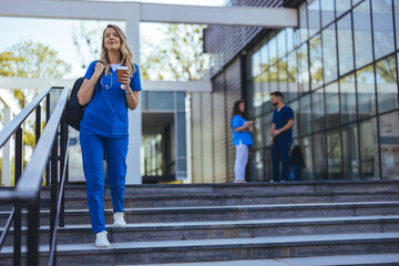 Confident Nurse Walking Outside Hospital with Coffee in Hand