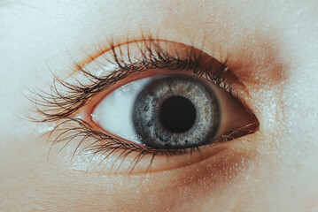 A close up of a person's eye with a dark pupil