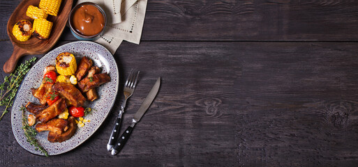 Slow cooked pork spare ribs in a barbecue sauce. View from above, top studio shot with copy space