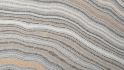 A gray and beige marble with wavy lines