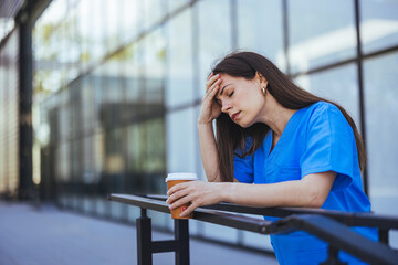 Exhausted Healthcare Worker Taking a Break with Coffee Outdoors