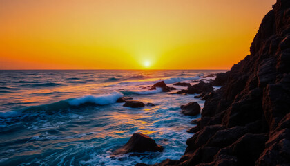Dramatic seascape: ocean shore waves crashing on rocks with spray in the rays of the setting sun.