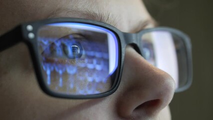 Reflection in glasses. Female doctor reading X-ray scans MRI images. Close up.