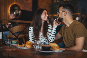 Romantic Couple Enjoying Breakfast in a Cosy Cafe Setting