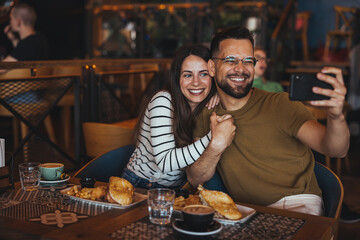 Happy Couple Taking Selfie in Cozy Cafe Setting