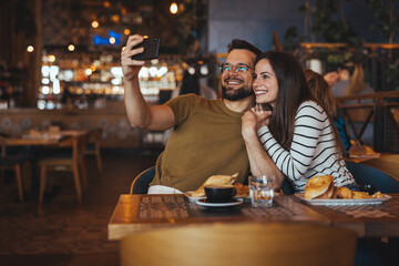 Happy Couple Taking Selfie in Cozy Restaurant Setting