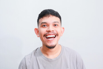 Young Adult Asian man smiling happy at the camera