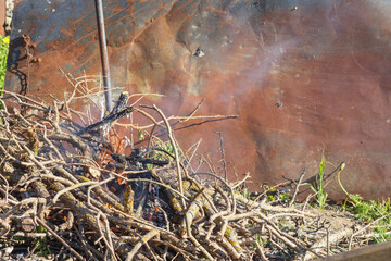
a pile of branches for a fire place on a metal tin background