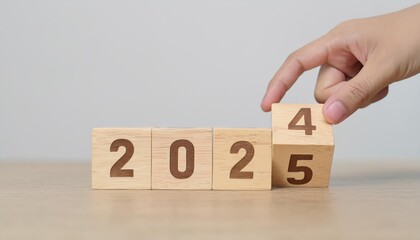hand flipping block 2024 to 2025 text on table