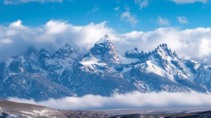 Fototapeta premium Snow-Blanketed Mountain Range with Jagged Peaks Piercing Through Clouds