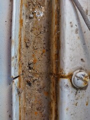 Rusty metal fold bar close-up