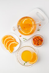Sea buckthorn tea drink with oranges and mint. Autumn comfort hot drink. Herbal vitamin tea. 
