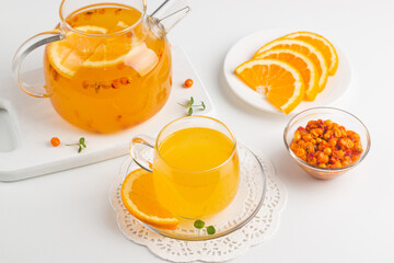 Sea buckthorn tea drink with oranges and mint. Autumn comfort hot drink. Herbal vitamin tea. 