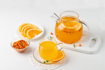 Sea buckthorn tea drink with oranges and mint. Autumn comfort hot drink. Herbal vitamin tea. 