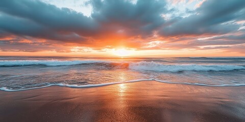 A breathtaking sunset casts its brilliant light on the ocean waves, creating a stunning display of colors and reflections in the water.