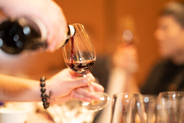 pouring red wine into glass