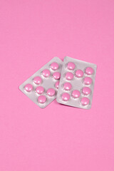 Pink Medicine Pills in Silver Blister Packs on Monochromatic Pink Background - Healthcare and Pharmaceutical Concept with Copy Space
