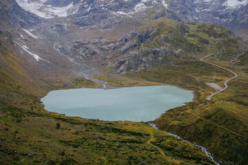 A beautiful lake placed between the Alps, a majestic landscape in the mountains.