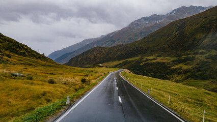 A beautiful road in the mountains, a landscape of a road that crosses the Alps.