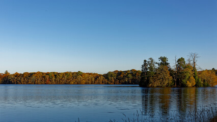 Clunie island and Castle set within the Loch of Clunie near to Forneth, Blairgowrie under a cold clear blue sky in November.