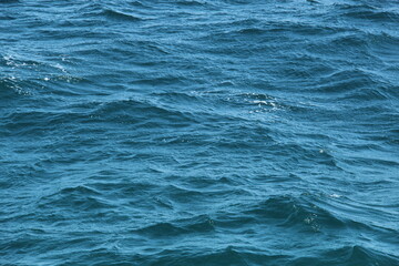 Photo of ocean blue water background surface with ripples