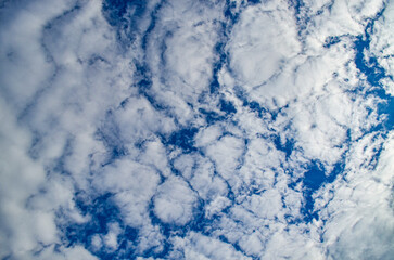 The sky is blue with white clouds. The clouds are fluffy and scattered throughout the sky.