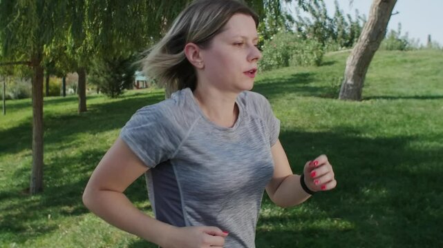Mature woman jogging in park and feeling pain in chest, heart attack at early 40.