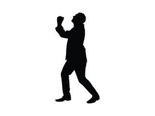 Silhouette of a man in a suit with hands clasped and looking up as if pleading for mercy or forgiveness or for praying
