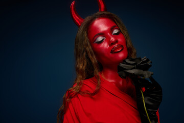 A radiant woman in a striking Halloween outfit poses confidently, blending beauty and creativity.