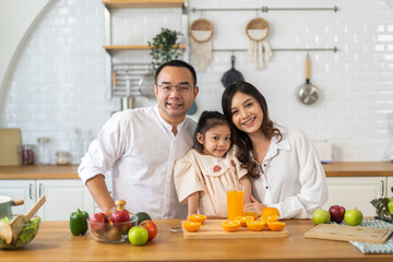 Family preparing fresh orange juice in kitchen, healthy lifestyle, bonding time, family activity, nutrition and wellness, parents and child, home cooking, healthy beverage, vitamin C, kitchen fun
