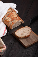Rustic Bread Display with Sliced Whole Grain Loaf in Wicker Basket on Wooden Table - Perfect for Bakery, Culinary, and Farmhouse Decor Themes