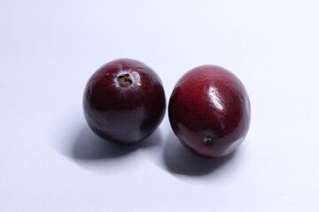 red cranberries on white background, macro shot