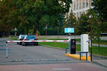 Automated barrier gate at parking lot entrance. Advanced automated boom barrier system in...