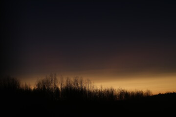 Sunset clouds mirrored in the window. Nature sunset sky backdrop. Blurry abstract sunrise background