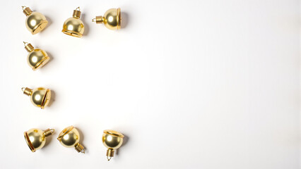 Festive bell decorations arranged on a minimal white background