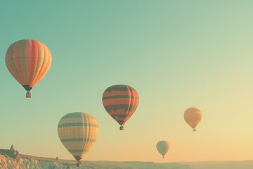 Obraz premium A set of brightly colored hot air balloons rising into a clear sky. 